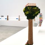 Modelle von Turmbauten: Im Vordergrund steht ein Modell, das einem Baum ähnelt. Im Hintergrund sind Modelle aus Papier und Holz auf weißen Sockeln positioniert.