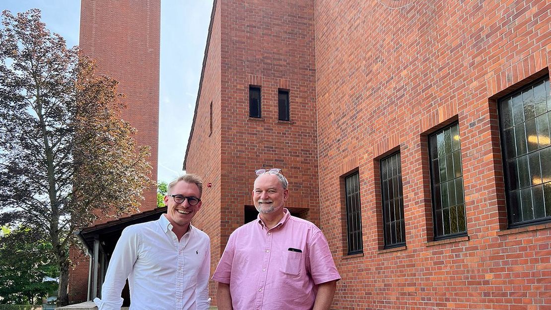 Kita Johanneskirche Pink Posthaus Zwei Männer vor der modernen Backsteinkirche stehend